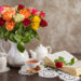 still life roses, tea and a book on the table
