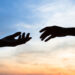 two hands silhouette on sky background, connection or help concept