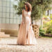 Beautiful woman posing in an elegant maxi dress outdoors. Jupiter in Taurus luxury and nature concept